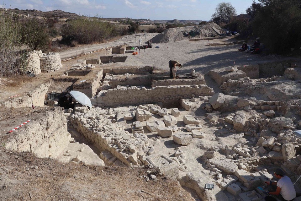 For more than a century, the Sanctuary of Apollo at Frangissa survived mostly as an old archaeological story. First explored in 1885, then poorly published and eventually lost from the map, the rural sanctuary near Pera Oreinis in Cyprus had become one of those places known more through fragments than through the ground itself.

Now archaeologists have returned to the site with modern methods, and the sanctuary is beginning to speak again.

The latest excavation at Frangissa has uncovered more than 20 ancient votive statue bases still standing in their original positions. Some still preserve the feet of the statues that once rose above them. Others were found tightly arranged beside earlier dedications, creating a rare view of how worshippers shaped, crowded, and renewed a sacred space over generations.

The discovery was announced by Cyprus’ Department of Antiquities following the fifth modern excavation season at the Sanctuary of Apollo. The project is directed by Dr. Matthias Recke of the University of Frankfurt, with fieldwork led by Dr. Philipp Kobusch of the University of Rostock.

Ancient offerings found in their original sacred layout

The most striking part of the discovery is not simply the number of statue bases. It is their position.

In many ancient sanctuaries, offerings were broken, moved, reused, or scattered by later building activity and early excavations. Frangissa is different. Archaeologists found a group of votive bases still standing where ancient worshippers had placed them more than 2,500 years ago.

That makes the sanctuary unusually valuable. Instead of studying isolated objects removed from their setting, researchers can now examine how the dedications were arranged inside the sacred area. The bases show how worshippers approached the god, where they placed their offerings, and how later generations respected or reorganized older monuments.

Some bases had been set so closely together that the sanctuary must have looked dense with statues. In other places, newer dedications were placed above older ones in a way that allowed both to remain visible. This suggests that Frangissa was not repeatedly cleared and rebuilt from scratch. Its sacred memory was layered.

Clay figures stood on stone pedestals

One detail from the excavation may change how scholars understand votive practice in ancient Cyprus.

Archaeologists found terracotta feet attached to several limestone bases. This provides the first clear archaeological evidence in Cyprus that clay votive figures could be mounted on carved stone pedestals, rather than simply being placed on the ground.

The detail is small, but important. Terracotta votive figures were common in Cypriot sanctuaries, while limestone statuary also played a major role in local religious art. At Frangissa, the two traditions appear to meet physically. Clay figures could be elevated, displayed, and integrated into the same monumental language as stone sculpture.

That tells us something about ancient worshippers. These offerings were not casual deposits. They were arranged for visibility. They had a place, a height, and probably a social meaning.

A forgotten sanctuary returns after 140 years

The Sanctuary of Apollo at Frangissa was first excavated in 1885 by the German archaeologist Max Ohnefalsch-Richter, one of the early figures in Cypriot archaeology. His work brought important finds to light, but the excavation was never fully published by modern standards. Over time, even the exact location of the sanctuary was forgotten.

Modern surveys eventually identified the site again near the village of Pera Oreinis, in the foothills west of Nicosia. The renewed excavation has allowed researchers to study the sanctuary with proper stratigraphic recording, careful documentation, and a much clearer sense of context.

The location matters. Frangissa stood in the island’s interior, away from the coastal cities that often dominate the archaeology of ancient Cyprus. Rural sanctuaries like this were not marginal spaces. They connected local communities, trade routes, political identities, and religious devotion.

Apollo was one of the most important gods worshipped in ancient Cyprus. Associated with protection, healing, music, prophecy, and sacred landscapes, he often occupied a powerful place in rural religious life. At Frangissa, his sanctuary appears to have served as a place where communities expressed status, memory, and devotion through visible offerings.

Older dedications were buried beneath a new ritual layer

The excavation also confirmed the sanctuary’s Archaic-period phase through undisturbed layers of pottery. Until now, this early phase had mostly been suggested by sculpture fragments found around the site. The discovery of intact Archaic layers gives archaeologists firmer evidence for the sanctuary’s chronology.

Even more intriguing is what happened later.

Researchers found that some earlier statue bases had been intentionally covered with leveling material before a new layer of monuments was installed above them. More than 100 additional statue bases, probably uncovered during the 1885 excavation and later dumped into refill soil, were also recovered during the current campaign.

This raises a central question. Was the sanctuary reorganized after destruction, perhaps caused by unrest or natural disaster? Or did the sacred space simply become too crowded as its popularity grew?

For now, archaeologists are keeping both possibilities open. What is clear is that Frangissa did not remain static. It changed, expanded, and absorbed older offerings into new ritual arrangements.

Frangissa opens a rare window onto ancient Cyprus

The rediscovery of the Sanctuary of Apollo is becoming one of the most important recent developments in Cypriot sanctuary archaeology. Its value lies in the combination of preserved layout, intact pottery layers, terracotta fragments, and evidence for long-term ritual change.

Together, these finds show how ancient Cypriots used sacred space not only to honor a god, but also to display memory, wealth, and identity. A votive statue was more than an object. It was a public statement, placed where others could see it and where the god was believed to receive it.

Further excavations are expected to clarify the sanctuary’s architectural development, possible destruction phases, and changing ritual practices from the Archaic through the Hellenistic period.

For a site once lost after its first excavation, Frangissa has returned with unusual force. More than 140 years after archaeologists first entered the sanctuary, its ancient offerings are finally being read where they were meant to stand.
