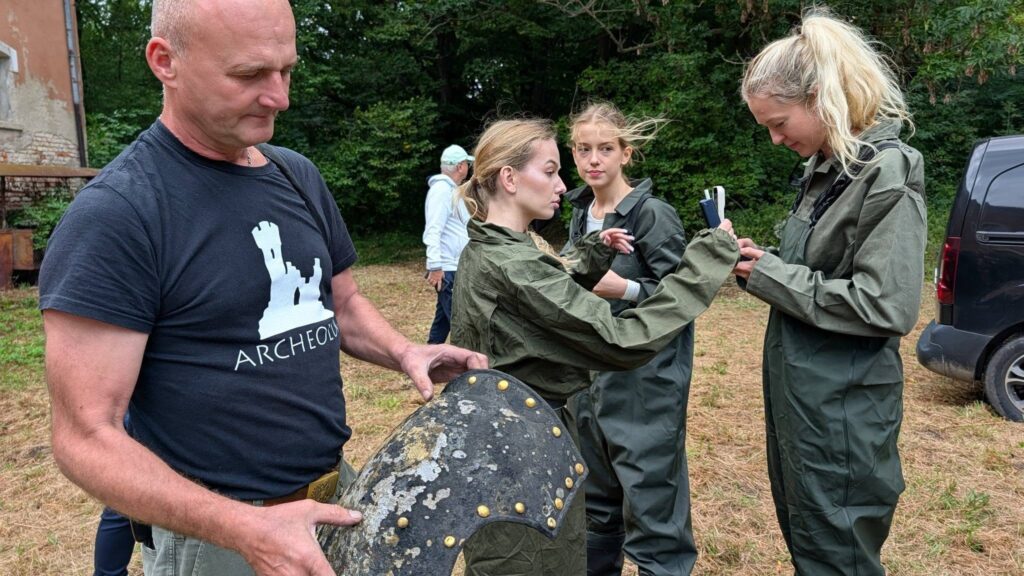 Search team examining the 19th-century cavalry breastplate found at Pielaszkowice Palace