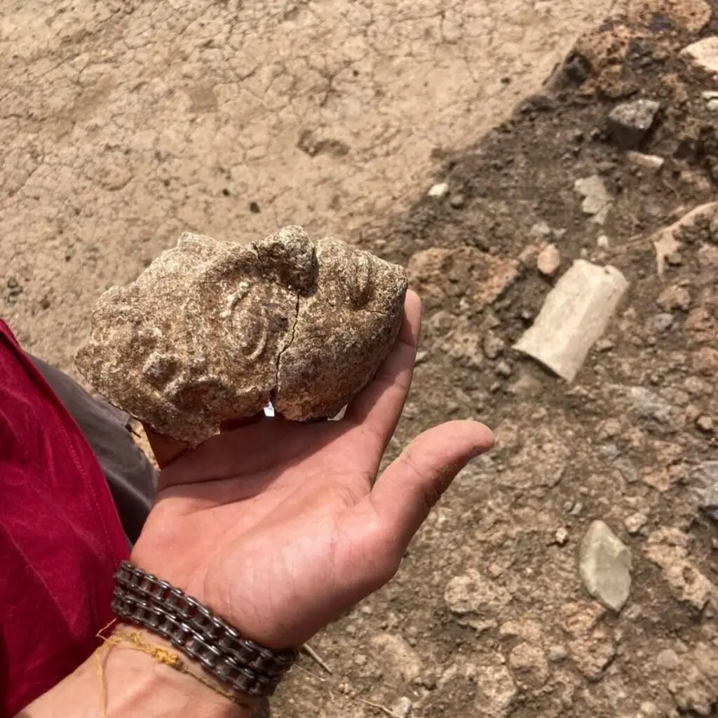 Side view of the newly excavated Etruscan terracotta antefix fragment depicting Uni.