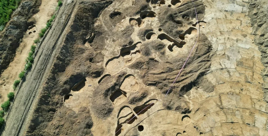 Aerial view of pits and excavated areas along the planned highway route.