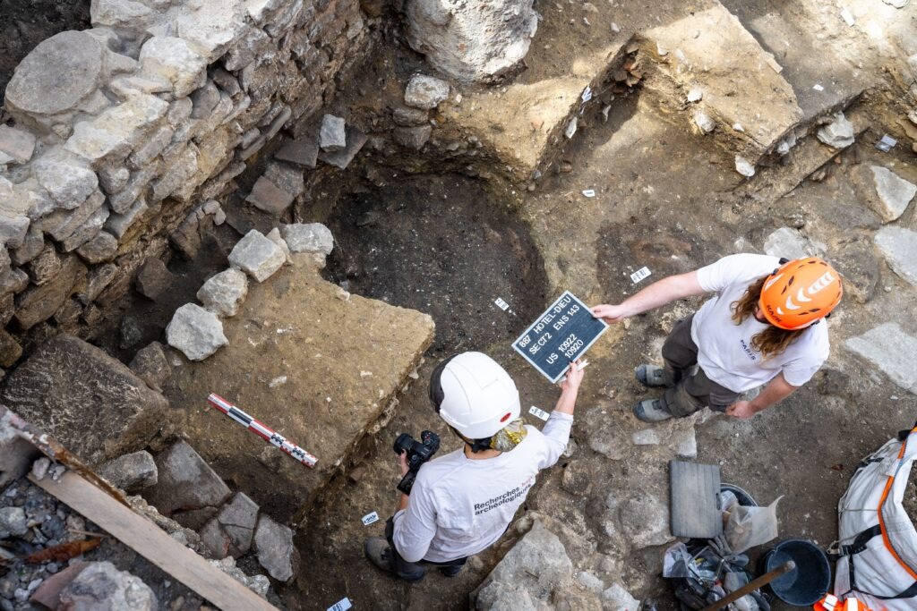 Overhead view of archaeologists documenting the Hôtel-Dieu excavation.