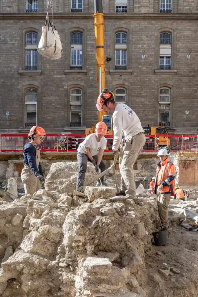 Archaeologists working among stone remains at the Hôtel-Dieu excavation.