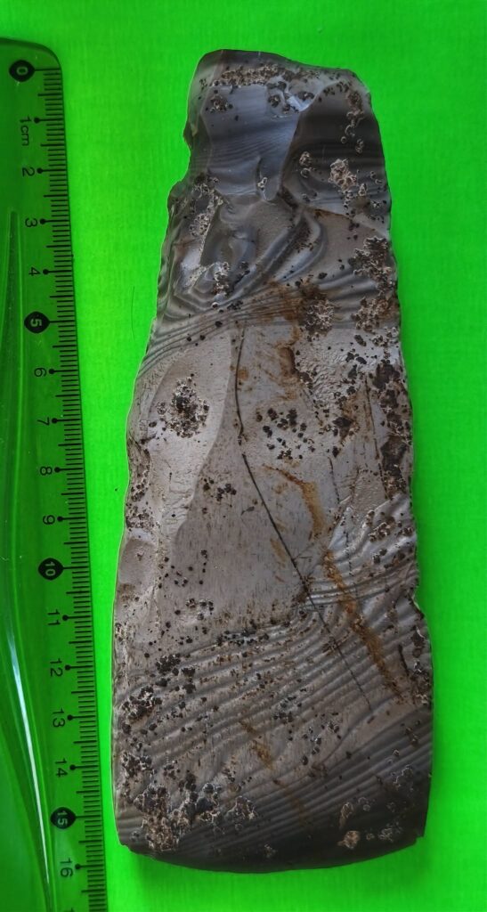 Top view of the 16-centimeter-long Neolithic axe made from striped flint