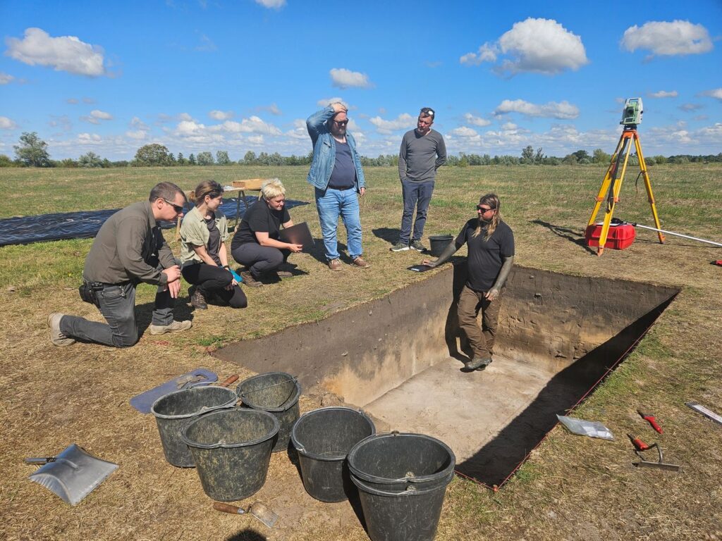 Archaeologists examining an excavation trench at the Pilatsch Slavic stronghold in Brandenburg, Germany.