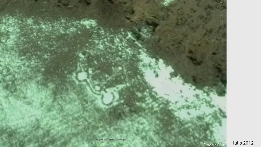 Older satellite image showing the connected stone circles beside snow-covered ground.