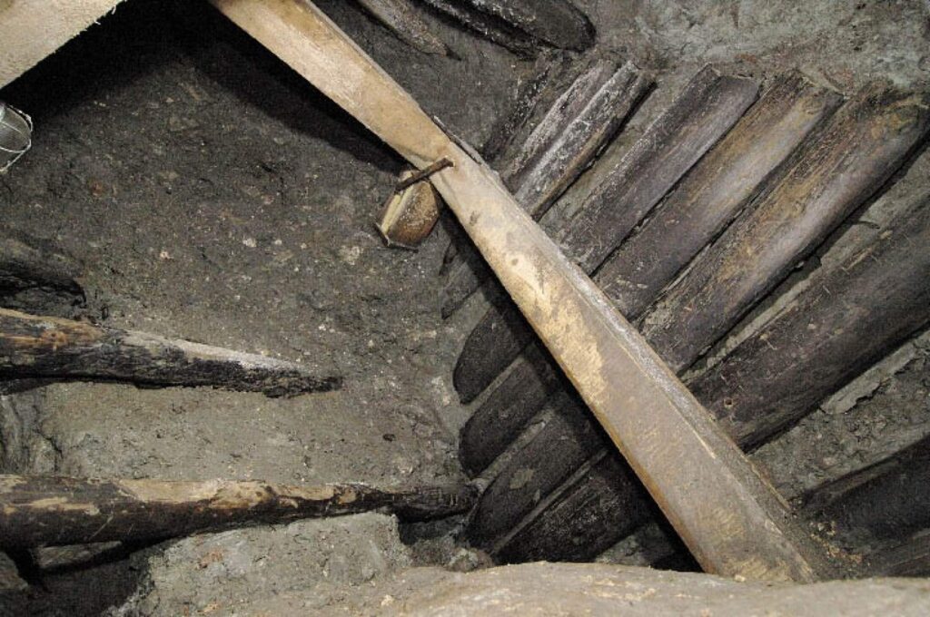Preserved wooden logs forming steps inside the narrow entrance to Hallstatt’s Iron Age salt mine.