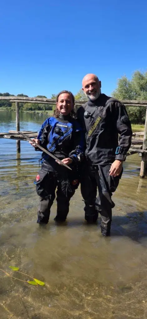 Two members of the underwater archaeological team holding the Bronze Age sword after its recovery from Lake Mezzano.
