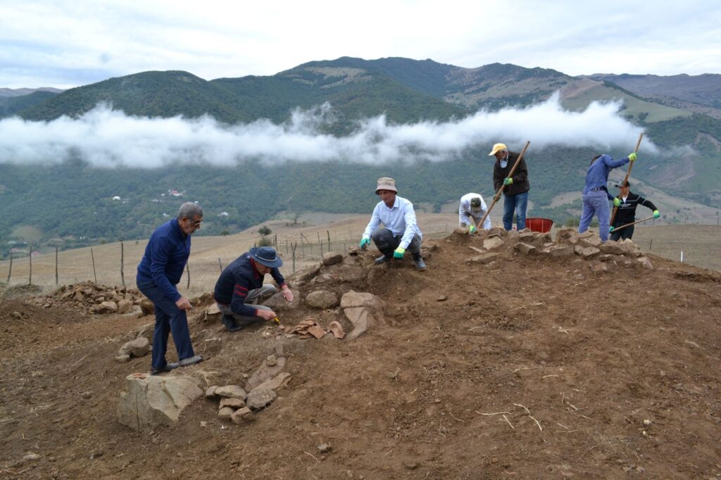 Archaeologists work at the Ökü burial mound in the mountains of southern Azerbaijan.