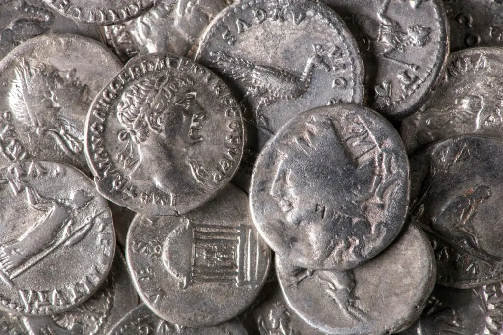 Close view of Roman silver coins, including a worn coin with a countermark on the right.