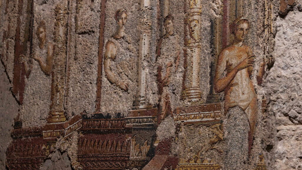 Human figures and decorated columns in the first-century Roman wall mosaic beneath the Baths of Trajan.