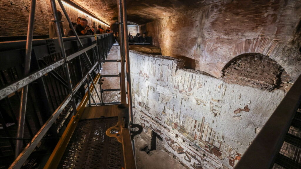 Visitors viewing the Great Mosaic from an elevated walkway beneath Rome’s Baths of Trajan.