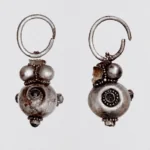 Restored silver Avar earrings with spherical pendants from a 1,400-year-old grave in Hungary.