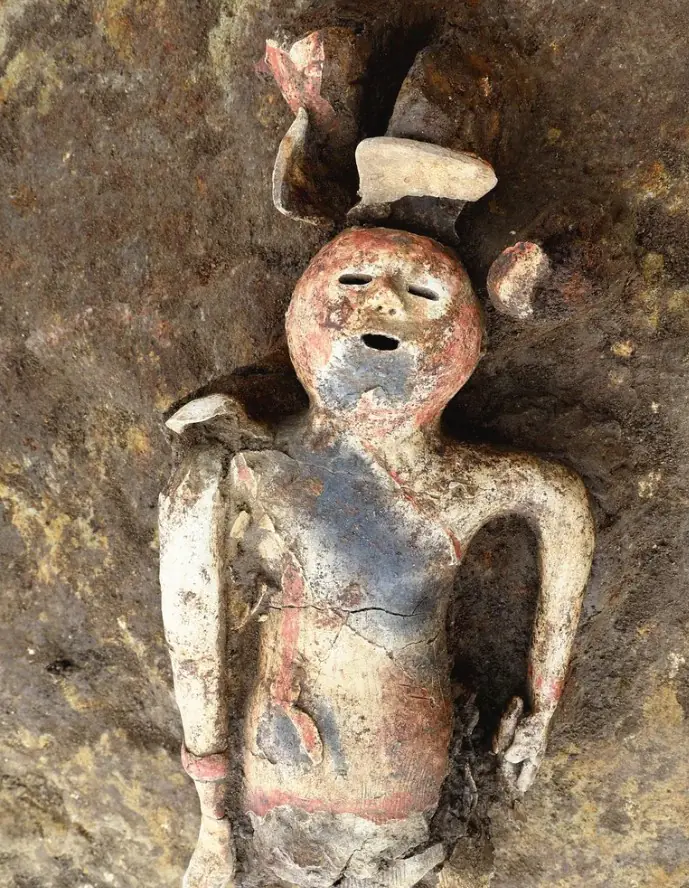 Close-up of a fifth-century haniwa figure from Gunma showing the face, upper body and traces of red paint.