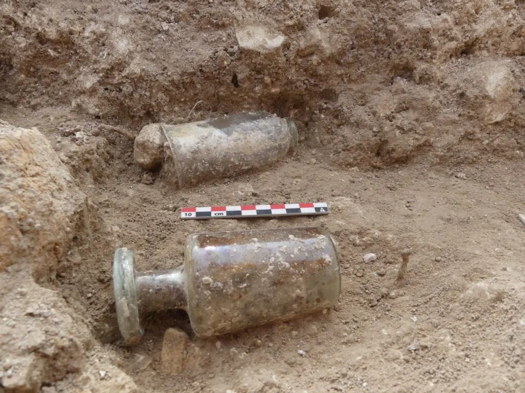 Two Roman glass vessels found inside a 1,700-year-old grave near Troyes, France.