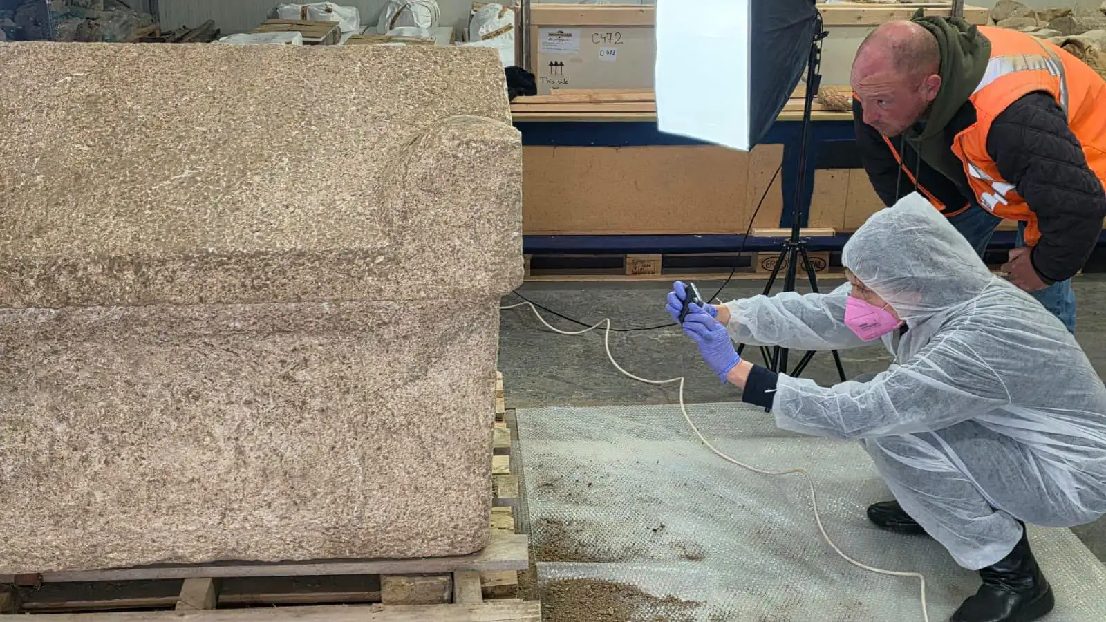 ntact 1,800-year-old Roman child's stone sarcophagus being documented by archaeologists in Constanța, Romania.