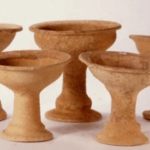 Five ancient ceramic chalices with wide bowls and pedestal bases from Pella, Jordan.