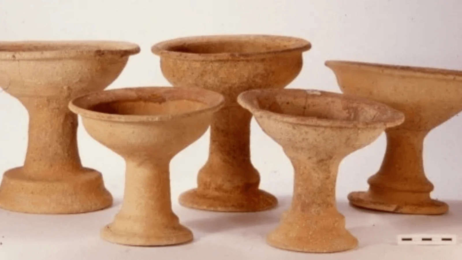 Five ancient ceramic chalices with wide bowls and pedestal bases from Pella, Jordan.