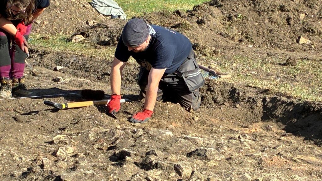 Archaeologist exposing structural remains at the medieval leprosy hospital site in Lincoln.