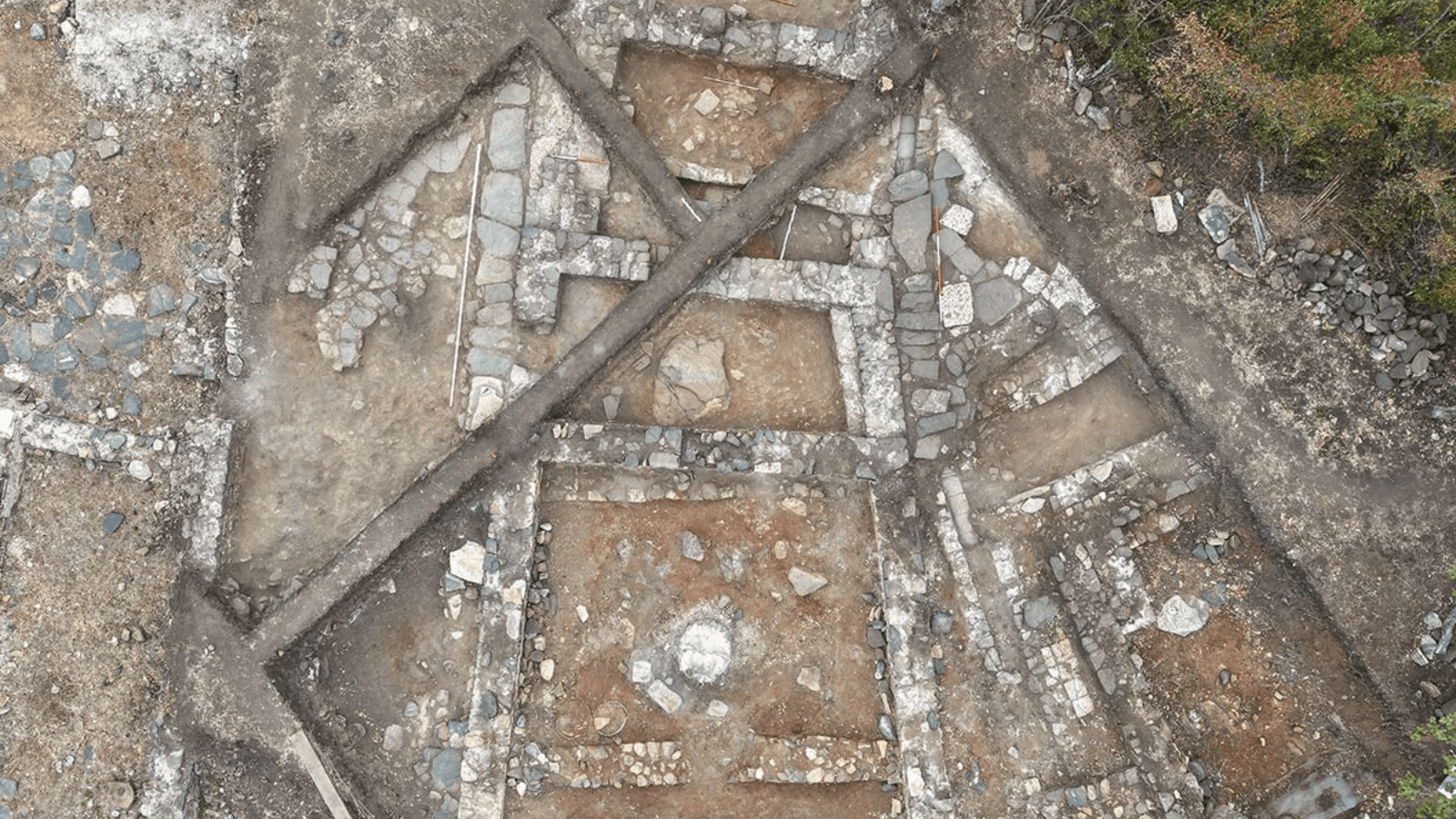 Aerial view of the excavated Thracian pagan temple at Balak Dere in Bulgaria, showing its trapezoidal architectural plan.
