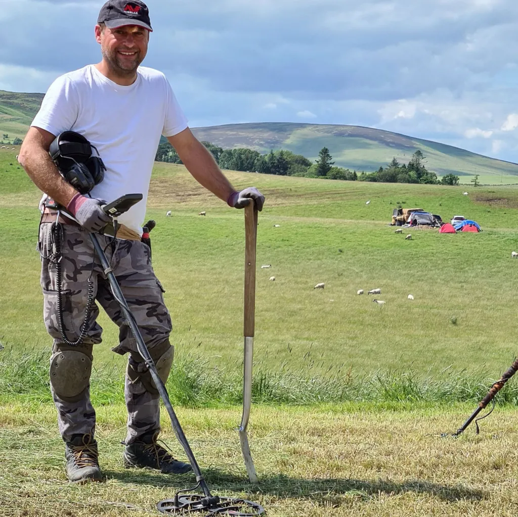 Metal detectorist Mariusz Stepien with his detector in the Scottish Borders.