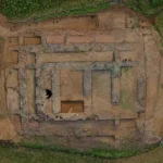 Aerial photograph showing the excavated layout and stone foundations of the Jandial D archaeological site in Pakistan.