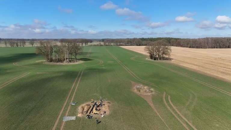 Drone photograph of archaeological excavations surrounded by agricultural fields at the Bronze Age settlement of Seddin.