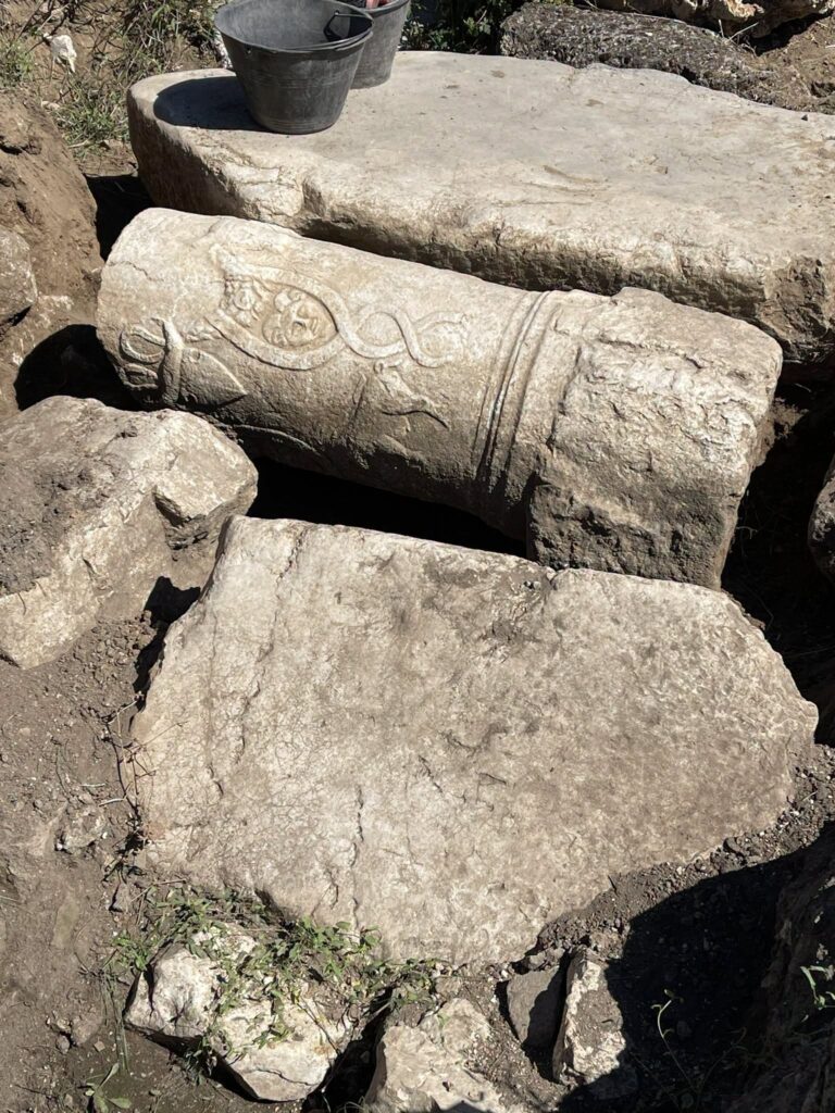 Decorated Roman cippus with inscription and carved reliefs uncovered at Aquinum