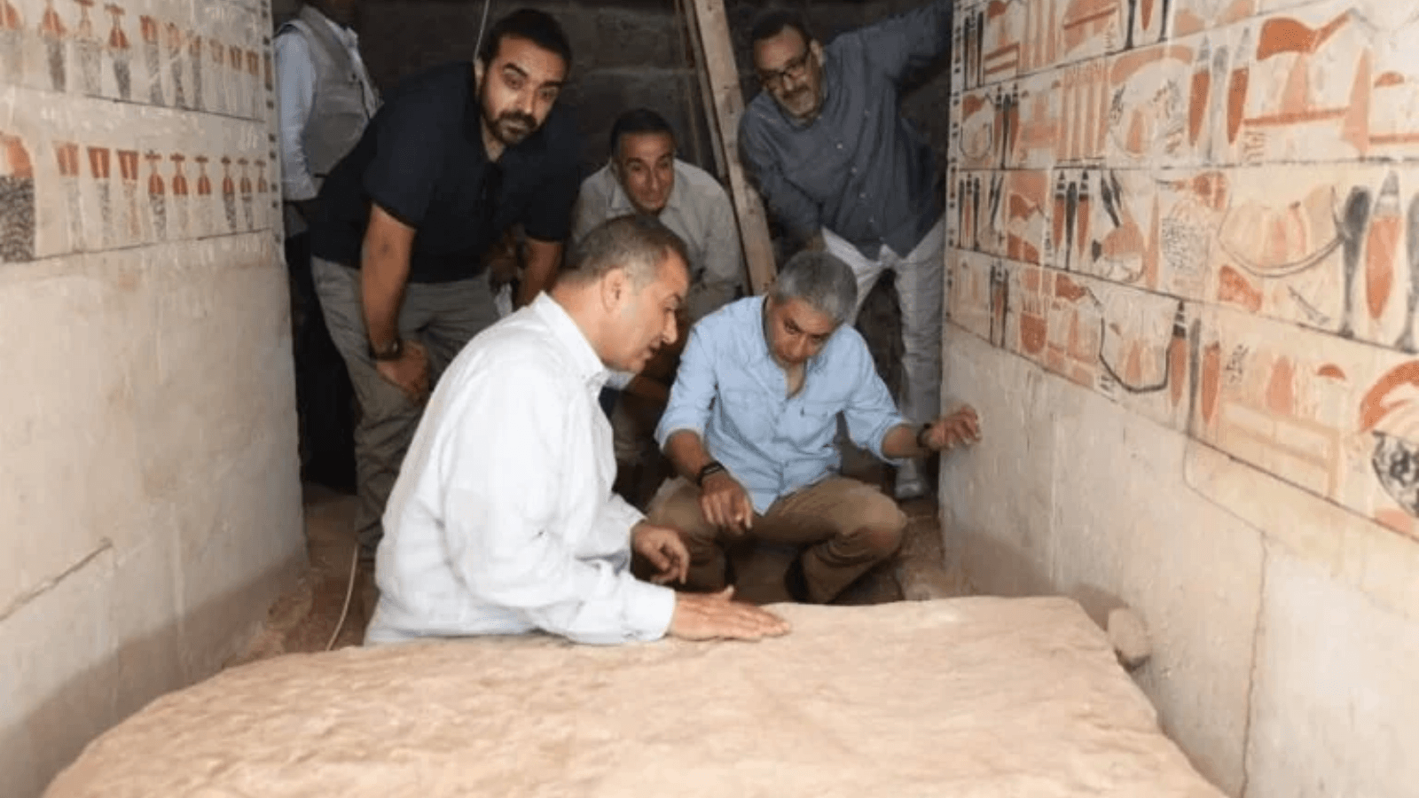Egyptian officials and archaeologists inside the newly discovered Old Kingdom tomb of Weni at Saqqara.